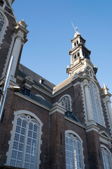 Fototapeta premium Facade of famous Westerkerk church on the Prinsengracht in the Netherlands with blue sky