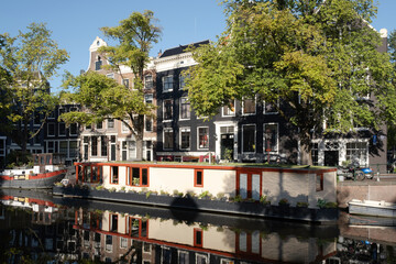 Houses and houseboat mirror in the water of the Prinsengracht right opposite the Anne Frank house...