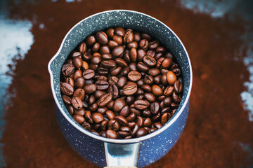 On the ground coffee is a beautiful blue turka, which is filled with roasted coffee beans, which will then be made strong coffee.