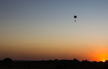 parachutist landing at sunset in the middle of winter late afternoon magnificent landscape