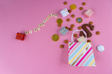 Dutch holiday Sinterklaas Greeting Card. St Nicholas Day background with traditional food - pepernoten, chocolate letter, gift, carrots for horse. Concept for party in Saint Nicolas day five december