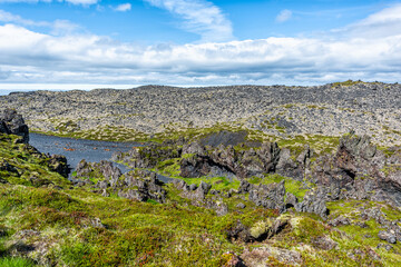 Fototapeta na wymiar Snaefellsjokull, Iceland national park with high angle view of Djupalonssandur Beach in Hellnar and green grass rocky volcanic landscape