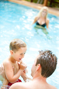 Swimming: Father Helping Boy to Learn to Swim