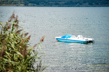 Punta del Lago with Vico lake Terni province and nobody landscape day view of blue water and peaceful water with blue boat