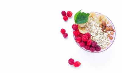 Healthy breakfast bowl: raspberry and fresh raspberry smoothie, banana, yogurt, nuts, oatmeal. Vegetarian concept, healthy food and diet. Top view, copy space.