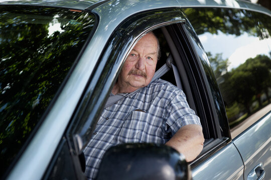Senior Man Sitting in Vehicle