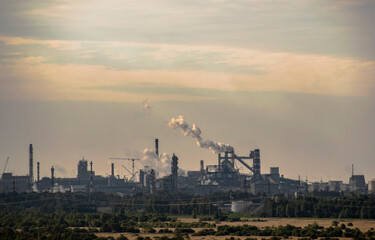Industrial plant in the haze of smog exhaled pipes.