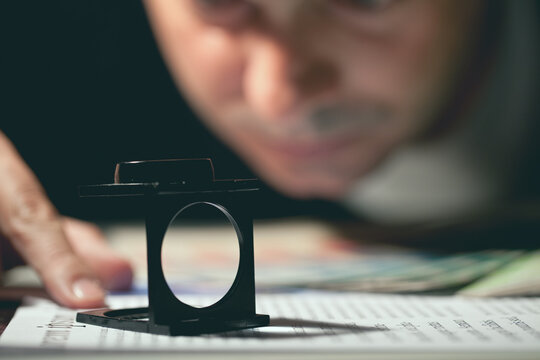 Graphic Designer Checking the Presswork with a Prover