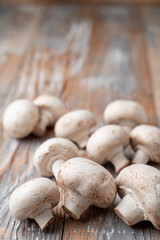 Bunch of champignons on light wooden table, close up photo for a market catalogue