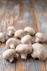 Bunch of champignons on light wooden table, close up photo for a market catalogue