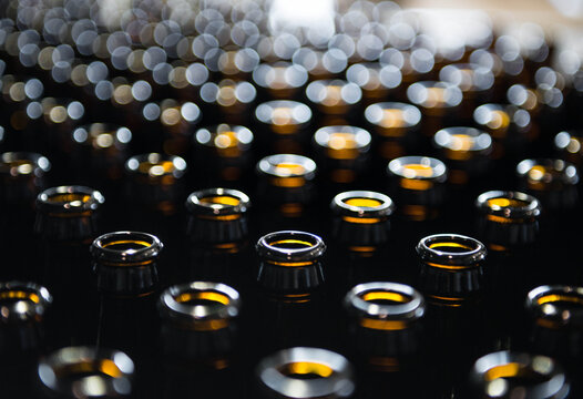 Beer bottles at a brewery are arranged for bottling