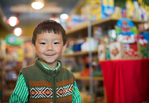 Smiling Asian Kid In a Toy Store