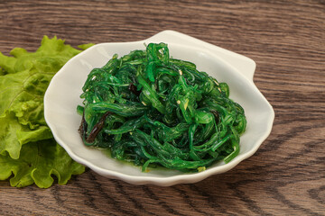 Green Chuka Seaweed Salad Isolated on White Background Top View. Wakame Sea Kelp Salat