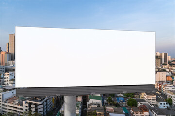 Fototapeta premium Blank white road billboard with Bangkok cityscape background at sunset. Street advertising poster, mock up, 3D rendering. Front view. The concept of marketing communication to promote or sell idea.