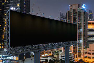 Obraz premium Blank black road billboard with Bangkok cityscape background at night time. Street advertising poster, mock up, 3D rendering. Side view. The concept of marketing communication to promote idea.