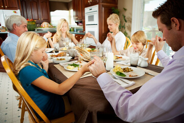 Thanksgiving: Family Saying a Blessing Before Dinner