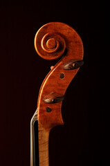 Close up sideview of violin scroll isolated on black  © Eric Hood