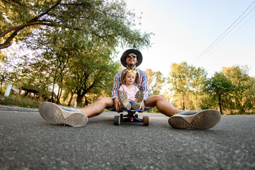 Young man skater resting sitting on skateboard with girl © fesenko