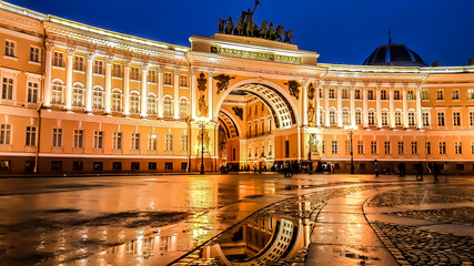 Arch of the General Staff on the Palace Square illuminated in the evening and reflecting in the puddle, Saint-Petersburg, Russia