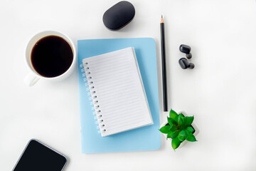 Female workspace with open notebook and pencil on a white table. Work from home, blogger workplace.