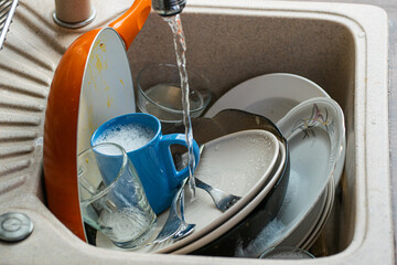 Dirty dishes in sink. © Dorottya Papp