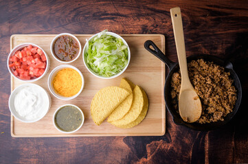 hard shell taco ingredients on wooden board