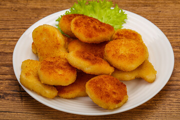 Fried chicken nuggets served salad leaves