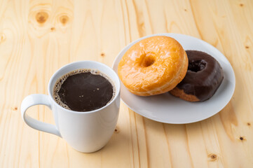 coffee and doughnut on bright pine table