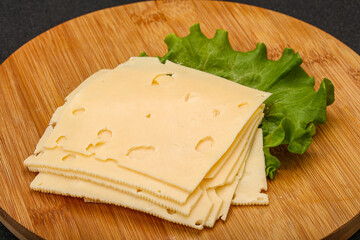 Sliced yellow cheese over board