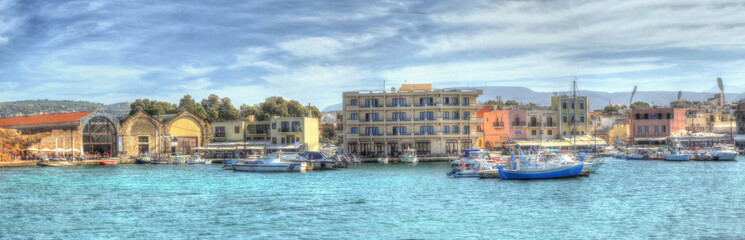 A view of the entrance to the main harbour and marina in Chania, Crete on a bright sunny day