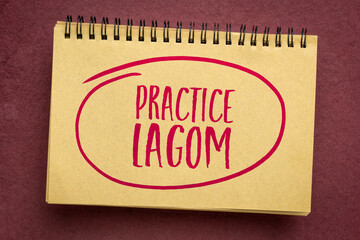 practice lagom - Swedish philosophy for a balanced life, handwriting in an art sketchbook, lifestyle concept