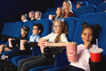 African girl with friends in cinema.