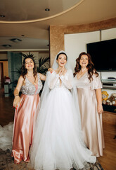 Emotional bride with bridesmaid posing in the room. Morning of the bride.
