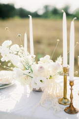 
bouquet of white flowers, candles, wedding table decor
