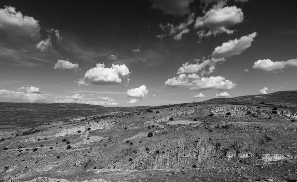 Mountains of desert in black and white with clouds on sky