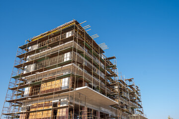 residential building construction site against a blue clear sky