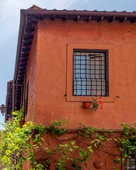 Fototapeta na wymiar vintage house window on colorful wall, Rome Italy