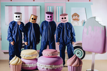 They are the best way to market the company's brand. Interesting ad. Four in a marshmallow man suit against the background of an ice cream maker depict items or discounts in their hands.