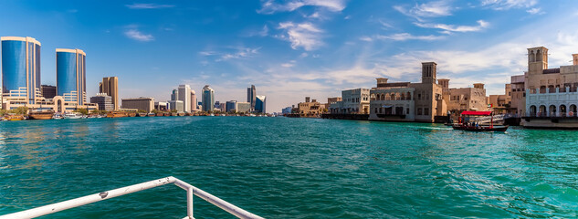 Fototapeta na wymiar A panorama view from a small boat of the upper reaches of the Dubai Creek in the UAE in springtime