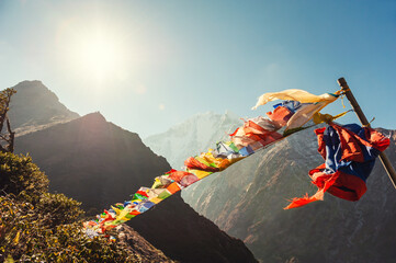 Buddhist prayer flags in Himalaya mountains at sunrise. View of Thamserku mount in Himalayas, Khumbu valley, Everest region, Nepal.