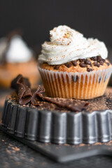 Homemade muffins with coffee and cinnamon. Food still life, dark mood.