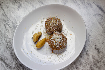 Ketogenic snack made with peanuts, brazil nuts and grated coconut. Selective focus