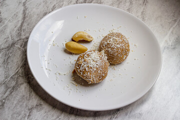 Ketogenic snack made with peanuts, brazil nuts and grated coconut. Top view and selective focus