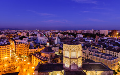 Sightseeing of Spain. Aerial view of Valencia old town at sunset. Illuminated city, panoramic cityscape of Valencia with beautiful sky.