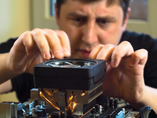 installing the cooler on the processor. the Assembly of a personal computer. workshop.