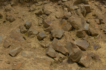 Old yellow stones and a sand high in the mountains. Textured materials. Closeup.