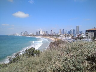 Fototapeta premium Nice view of the Mediterranean Sea and Tel Aviv in summer in Israel. Scenic views of the beaches and modern architecture of Tel Aviv. The photo can be used as a banner for advertising.