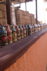 Jars with color sand in Mamshit market. The Israel national reserve.