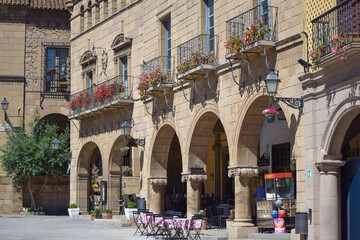 City photo of a building with columns and balconies in colors