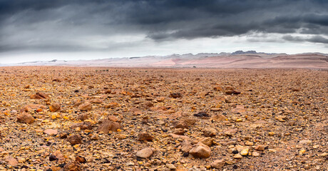Stony desert under a stormy sky.